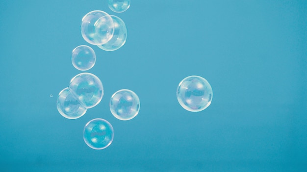 Photo shampoo bubbles isolated on blue