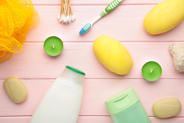 Shampoo, soap, aroma candles and other toiletry. Spring composition on pink wall