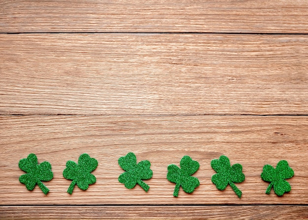 Shamrock clover on a wooden table, a symbol of the Irish holiday of St. Patrick's Day.