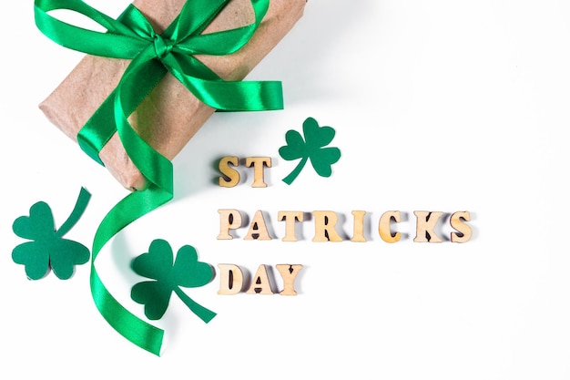 Shamrock and gift with green ribbon on a white background Good luck symbols for St Patrick's Day