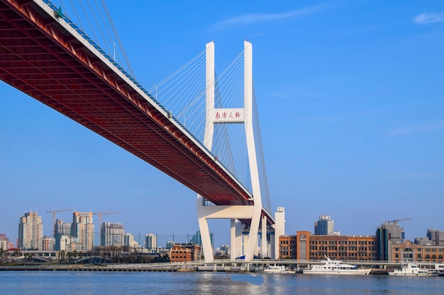 Shanghai, China - FEB 18, 2021: Nanpu Bridge is the first bridge to cross the Huangpu River from central Shanghai, linking it with the Pudong district across the river.