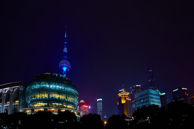 Shanghai China March 12 2016 Oriental Pearl TV Tower and commercial buildings located in the Lujiazui financial district at night