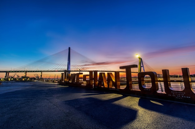 Shantou City, Guangdong Province, China. Chinese translation on the bridgeShantou Queshi bridge