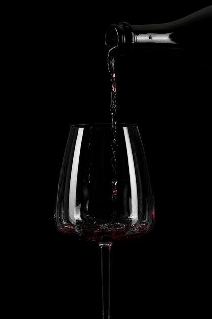 Shape of pouring wine in a tall glass