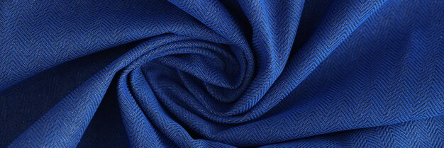 Shaped blue fabric background or design element wavy blue textile closeup