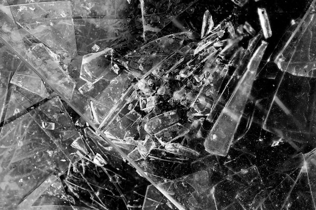 Shards of glass isolated on a black background. broken glass. High quality photo