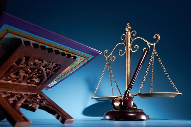 Sharia law concept gavel hammer libra scale and holly\
koran