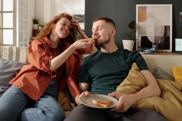 sharing appetizing pizza with boyfriend