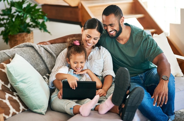 Photo sharing in the cutest connection shot of a happy family using a digital tablet together at home