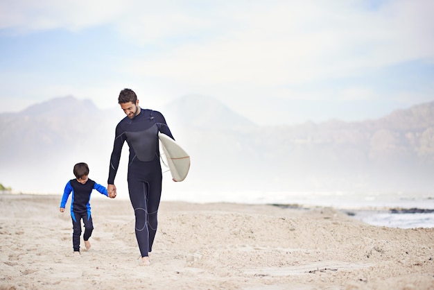 Sharing a passion for surfing with his son Shjot of a father and son enjoying a day outdoors