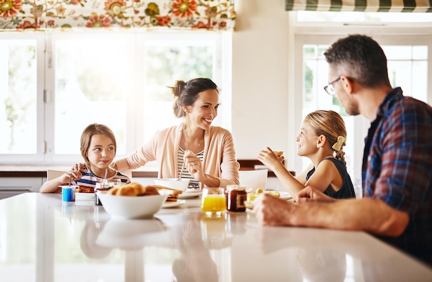 Photo sharing stories at the breakfast table cropped shot of a family enjoying breakfast together