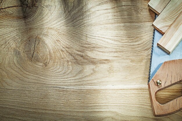 Sharp handsaw wooden planks on wood board construction concept