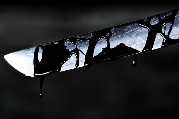 Sharp katana sword blade dripping black color painting