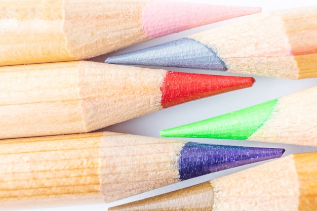 Sharpened art color pencils close up on white