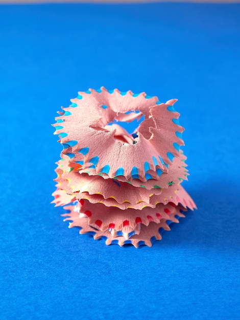 Sharpening shavings pile up blue background