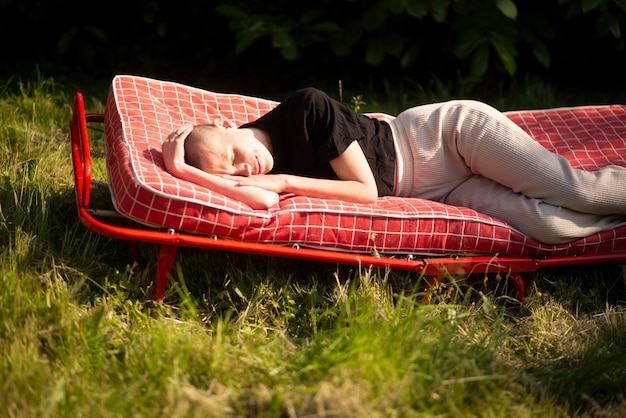 Shaved woman in summer garden