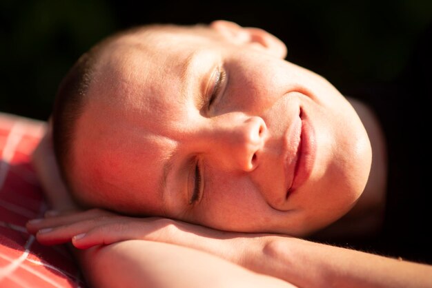 Shaved woman in summer garden