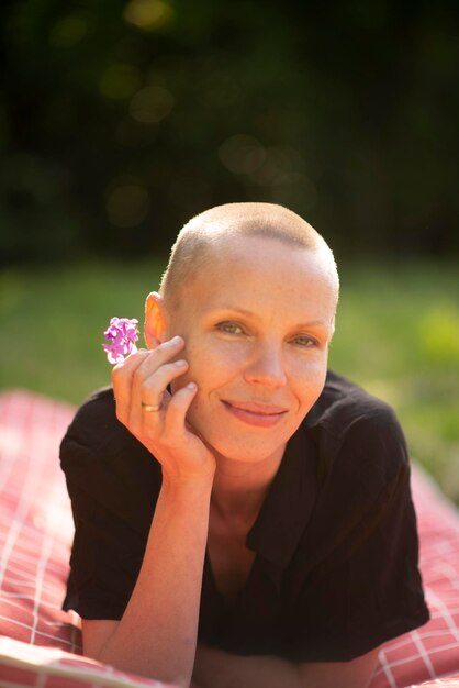 Shaved woman in summer garden