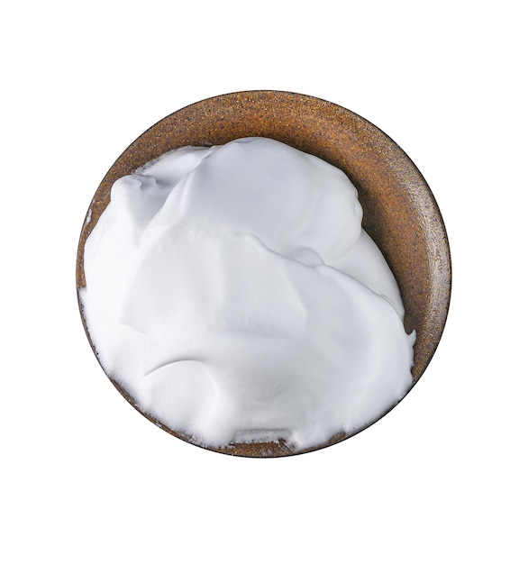 Shaving foam white cosmetic foam mousse cleanser in brown ceramic bowl isolated on a white Top view