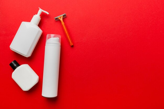 Shaving man set shaving machine towel lotion and shaving foam on colored background Men bath Accessories top view