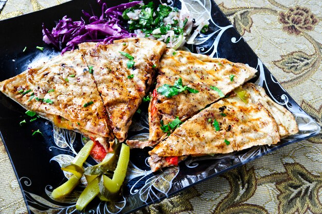 Shawarma sandwich (pita bread) with grilled meat, mushrooms. Traditional Middle Eastern snack.