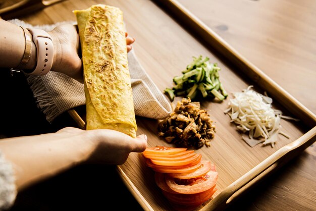 Shawarma sandwich t made of pita bread falafel Traditional Middle Eastern snack in hand on a wooden background recipe