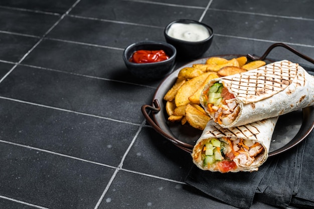 Photo shawarma shaurma kebab with meat vegetable salad and french fries black background top view copy space