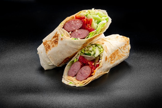 Shawarma with grilled sausage vegetables and tomato sauce Sausage in pita
