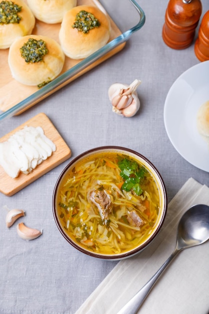 Shchi with pampushki buns and lard Soup of cabbage potatoes and meat Traditional Russian and Ukrainian cuisine Closeup