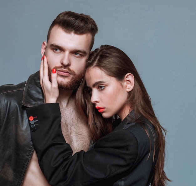 She adores male brutal beard Girlfriend passionate red lips and man leather jacket Passionate hug Couple passionate people in love Man brutal well groomed macho and attractive girl cuddling