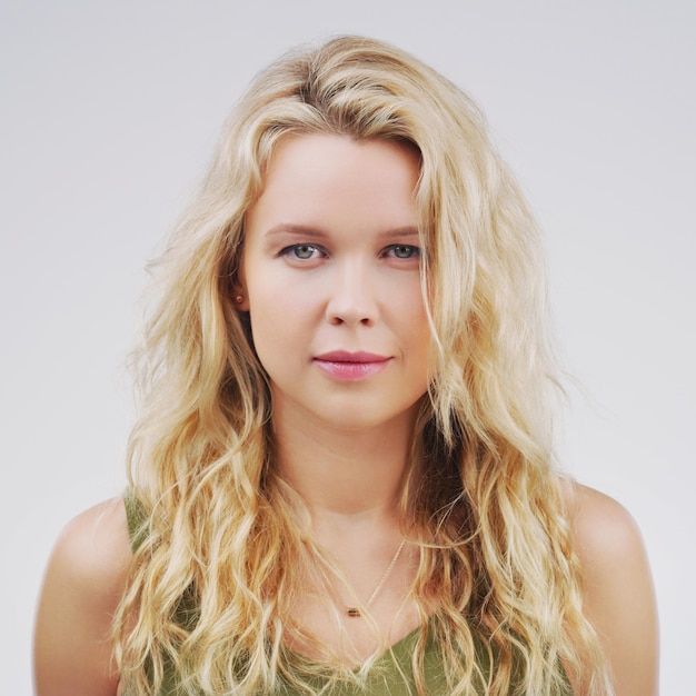 She gives nothing away Studio portrait of an attractive young woman posing expressionless against a grey background