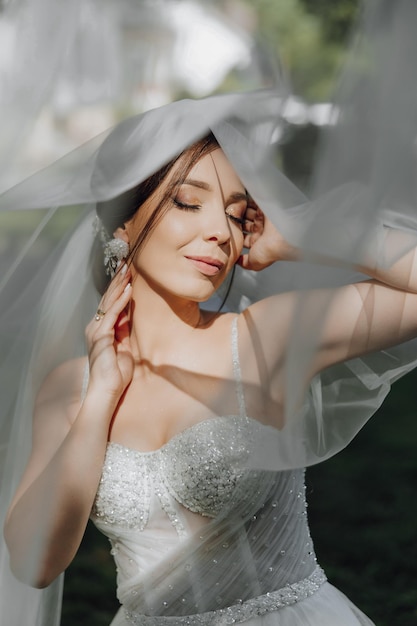 She is wearing a veil and has her hair pulled back