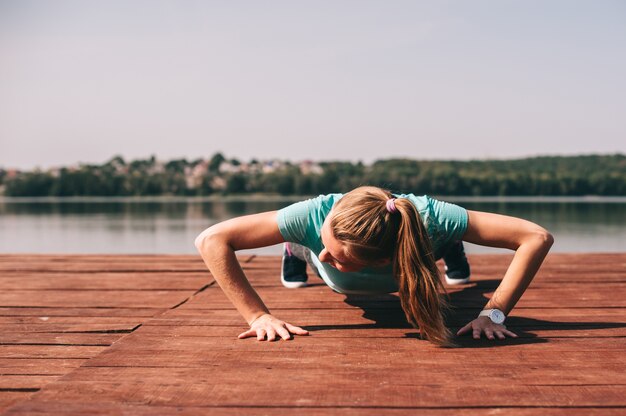 She performs exercises on pier