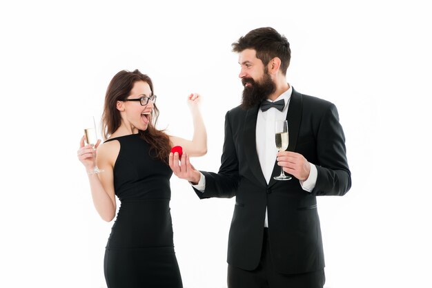 She said yes. Man with beard and woman happy celebrate anniversary. Couple in love dating anniversary. Couple man tuxedo and woman with champagne romantic anniversary. Proposal or engagement concept.