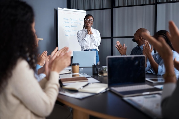 She should be impressed with herself Shot of a group of businesspeople clapping hands in a meeting at work