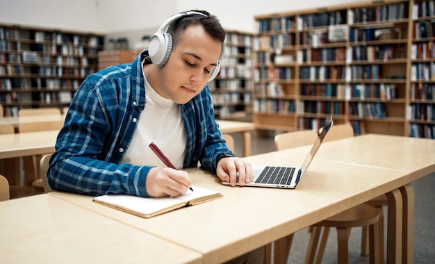 She studies online on the university's website The student studies literature in the library