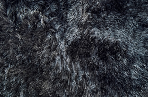 Photo sheepskin rug dark background texture sheep fur