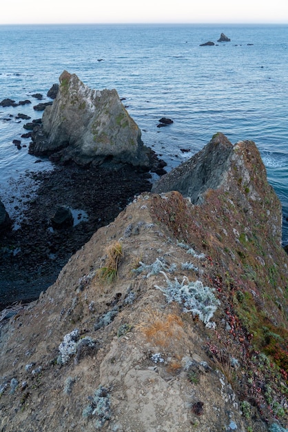 Sheer rock formations sheer rock formations sticking out of the\
pacific ocean at jenner california