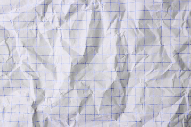 Photo sheet of crumpled checkered paper as background top view