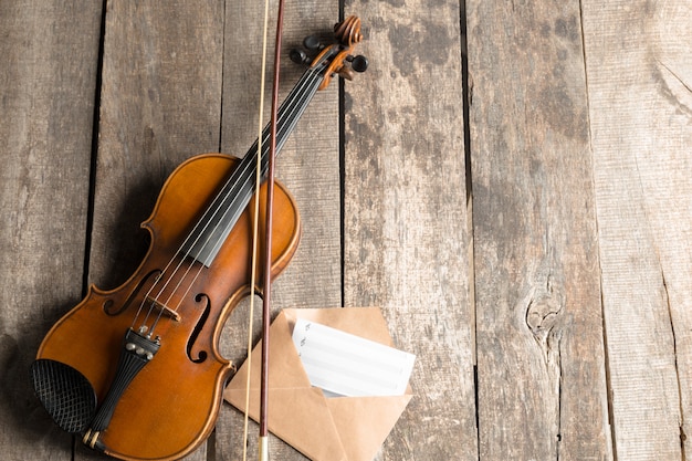 Sheet music and violin on wooden table