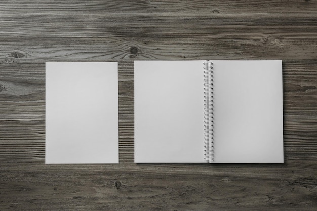 Sheet of paper and blank brochure on wooden table flat lay Mockup for design