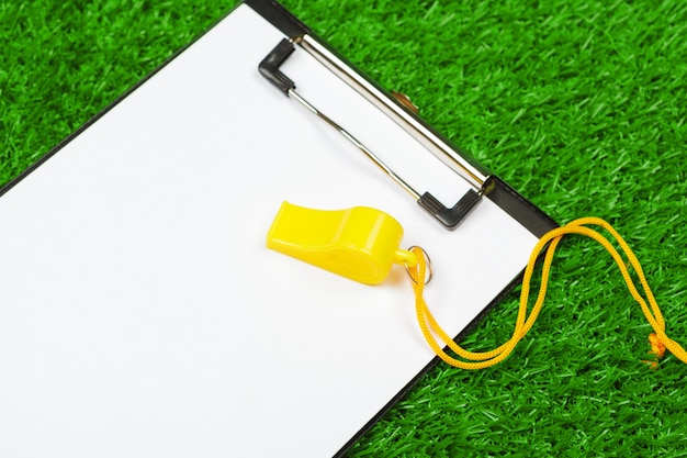 Sheet of paper on clipboard on the grass