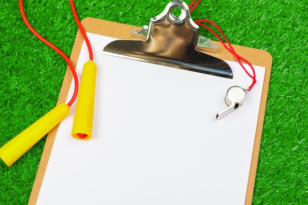 Photo sheet of paper and sports equipment on grass close-up