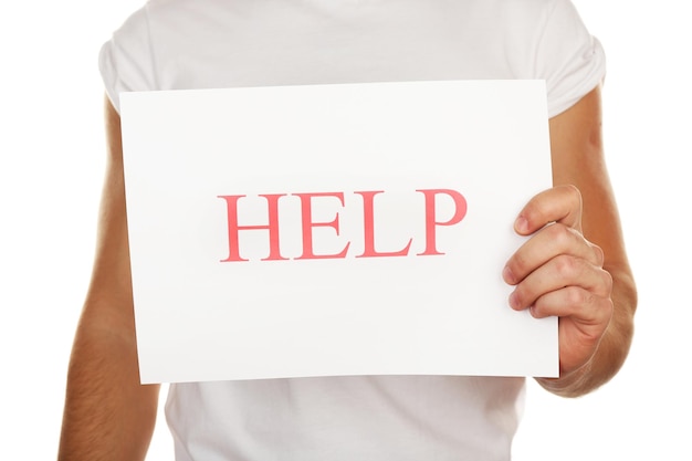 Sheet of paper with Help sign in male hand isolated on white