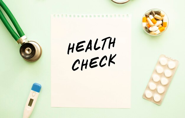 HEALTH CHECK 청진기 및 약물 텍스트가있는 종이