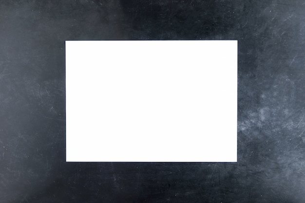 Sheet of white paper on black background