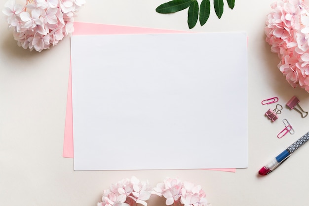 Sheets of paper surrounded by flowers