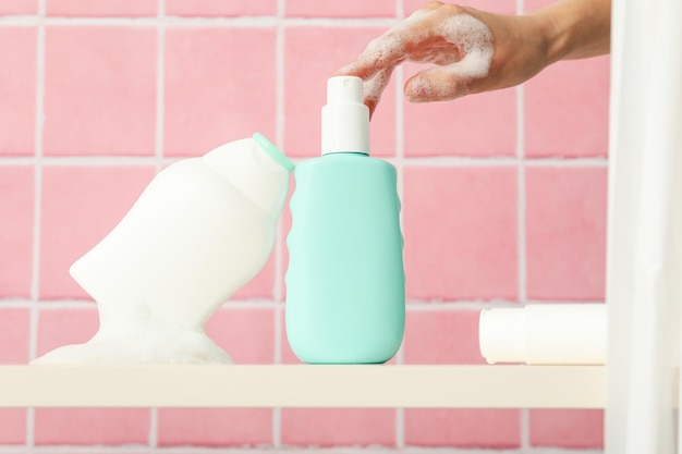 A shelf in the bathroom with care products