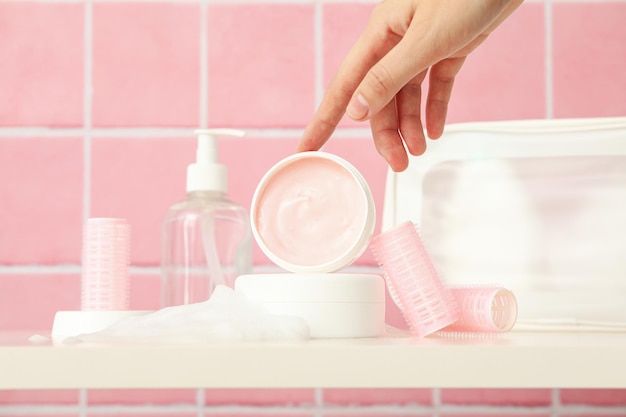 A shelf in the bathroom with care products