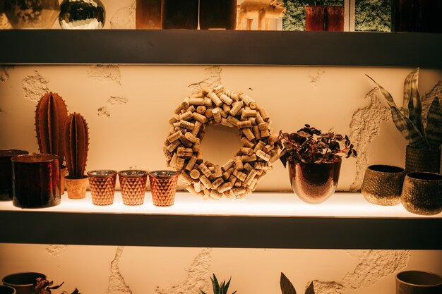 Photo shelf in the interior with decor, cork wreath